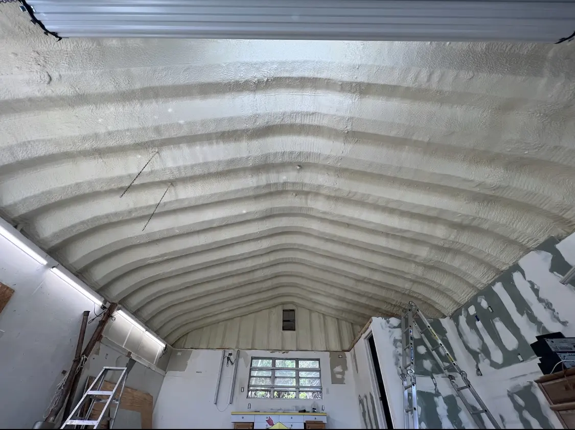 Spray polyurethane foam applied to the underside of a metal roof deck in Warsaw